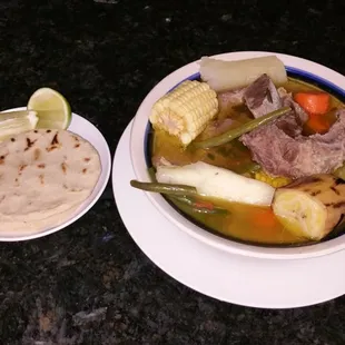a bowl of soup and a tortilla