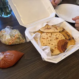 Pupusas, salsa roja and curtidos (both salsa and curtido come with the order of any pupusa.