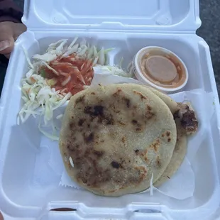 a person holding a tray of food