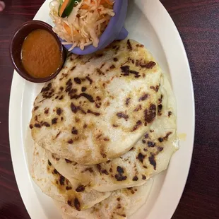 pupusas de chicharrón con queso + cortido y salsa.  Cortido is cabbage and carrot in pickled jalapeño juice.