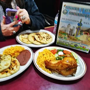 a woman taking a picture of her meal