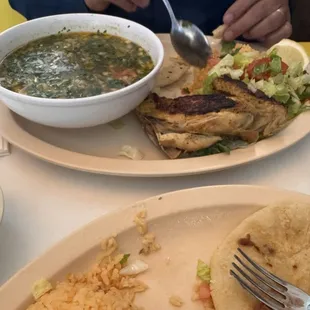Chicken soup with the chicken grilled on the side.