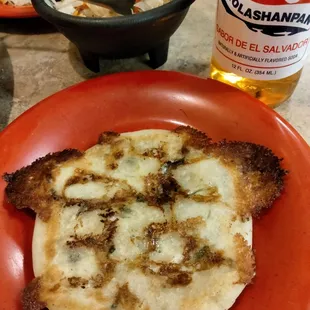 a plate of food and a bottle of beer