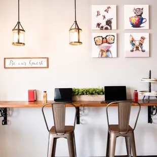 a table with two chairs and a laptop