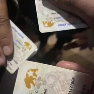 a person holding two cards in their hands