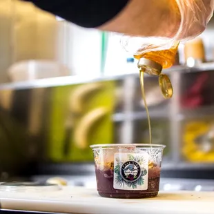 a person pouring coffee into a cup