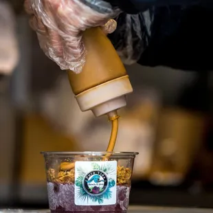 a person pouring coffee into a cup