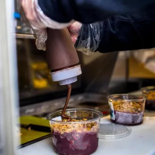 a person pouring something into a bowl