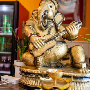 a statue of an elephant playing a guitar