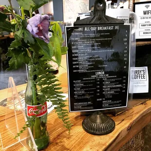  menu and a vase of flowers
