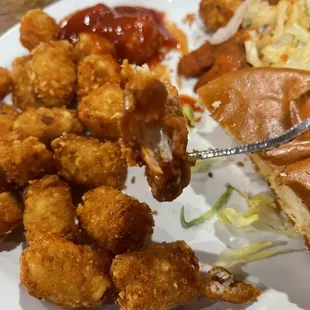 There&apos;s hardly any chicken in the minuscule chicken tenders, two of which are served on their $14 chicken sandwich. Tots for scale.