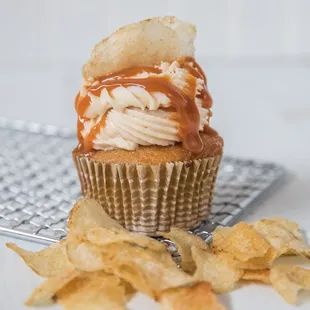 The Frankenstein: a vanilla cupcake filled with peanut butter sauce, then topped with caramel buttercream, caramel drizzle and potato chips!