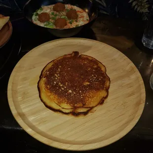 Grit bowl with salmon croquet accompanied by a pancake