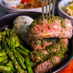 Chimichurri Steak
Grilled and seasoned Top Sirloin, with sautéed asparagus, red potato mash and a side of homemade chimichurri sauce.