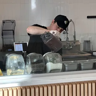 a man pouring water into a blender