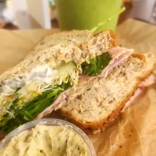 a sandwich cut in half with a side of mayonnaise