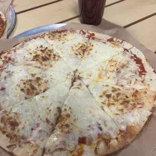 Cheese pizza and infant sized 8oz juice. Sourdough crust is prebaked/very chewy. Not worth even half of what it cost ($22 plus tax &amp; tip!)