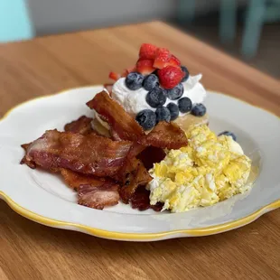 bacon, eggs, and berries on a plate