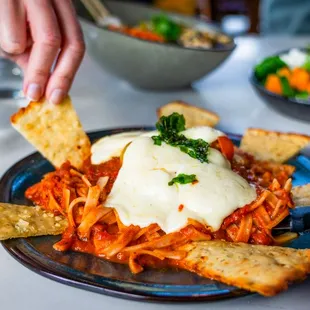 Gluten Free Chicken Parmesan G Panko crusted N.A.E. chicken breast, house-made mozzarella, fresh tomato, our marinara, rice noodle