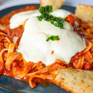Gluten Free Chicken Parmesan G Panko crusted N.A.E. chicken breast, house-made mozzarella, fresh tomato, our marinara, rice noodle