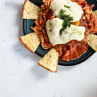 Gluten Free Chicken Parmesan G Panko crusted N.A.E. chicken breast, house-made mozzarella, fresh tomato, our marinara, rice noodle