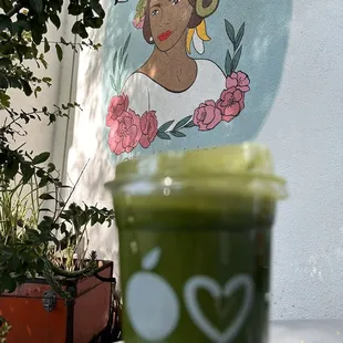 a green smoothie in a plastic cup