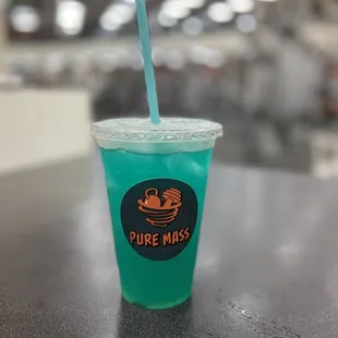 a blue drink in a plastic cup with a straw