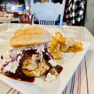 BBQ pulled pork sandwich served with coleslaw and homemade chips