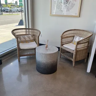 two wicker chairs and a coffee table