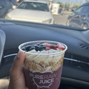 Traditional Acai Bowl with granola, bananas, blueberries, strawberries and honey