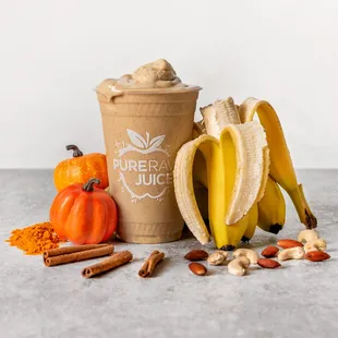 a cup of pure raw juice, a banana, nuts, and pumpkins
