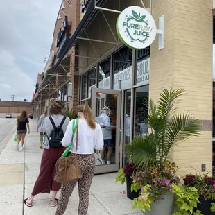 people walking in front of the store