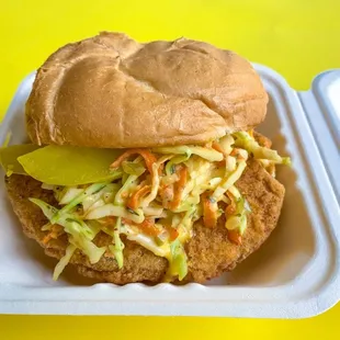 Fish sandwich, served with vegan slaw, pickles, and a tartar sauce on the side!