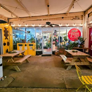 the inside of a restaurant with tables and benches