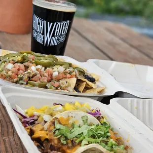 two plates of tacos and a drink