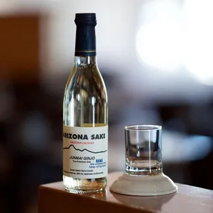 a bottle and a glass on a table