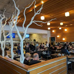 a large group of people eating in a restaurant