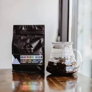 a coffee bag and a coffee pot on a table