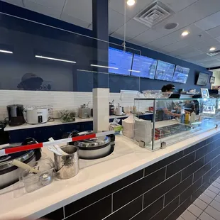 a restaurant counter with a variety of food items