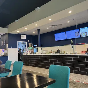 a woman sitting at a table in a restaurant