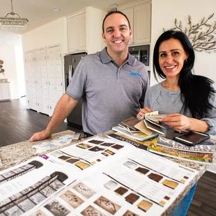 a man and a woman standing in a kitchen