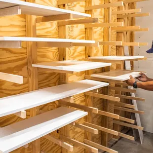 a man working on shelves in a workshop