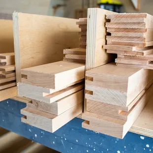 a stack of wood planks on a workbench