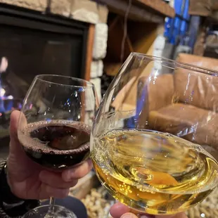 two people holding glasses of wine