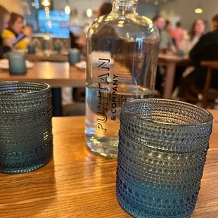 a glass and a bottle on a table