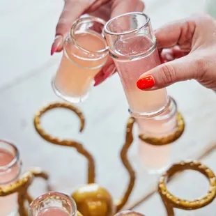 a woman&apos;s hand holding a glass of wine