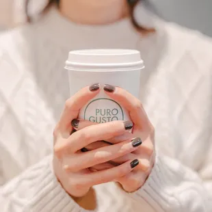 a woman holding a cup of coffee