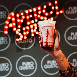 a hand holding a cup of coffee
