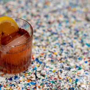 a drink in a glass with a slice of lemon