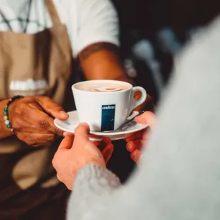 a person holding a cup of coffee